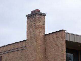 Smoke goes up the one chimney and back down the other.