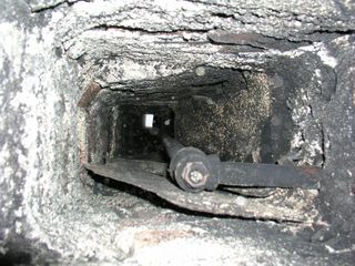 How can  I seal an old chimney if there are retrofit plumbing pipes running through it?